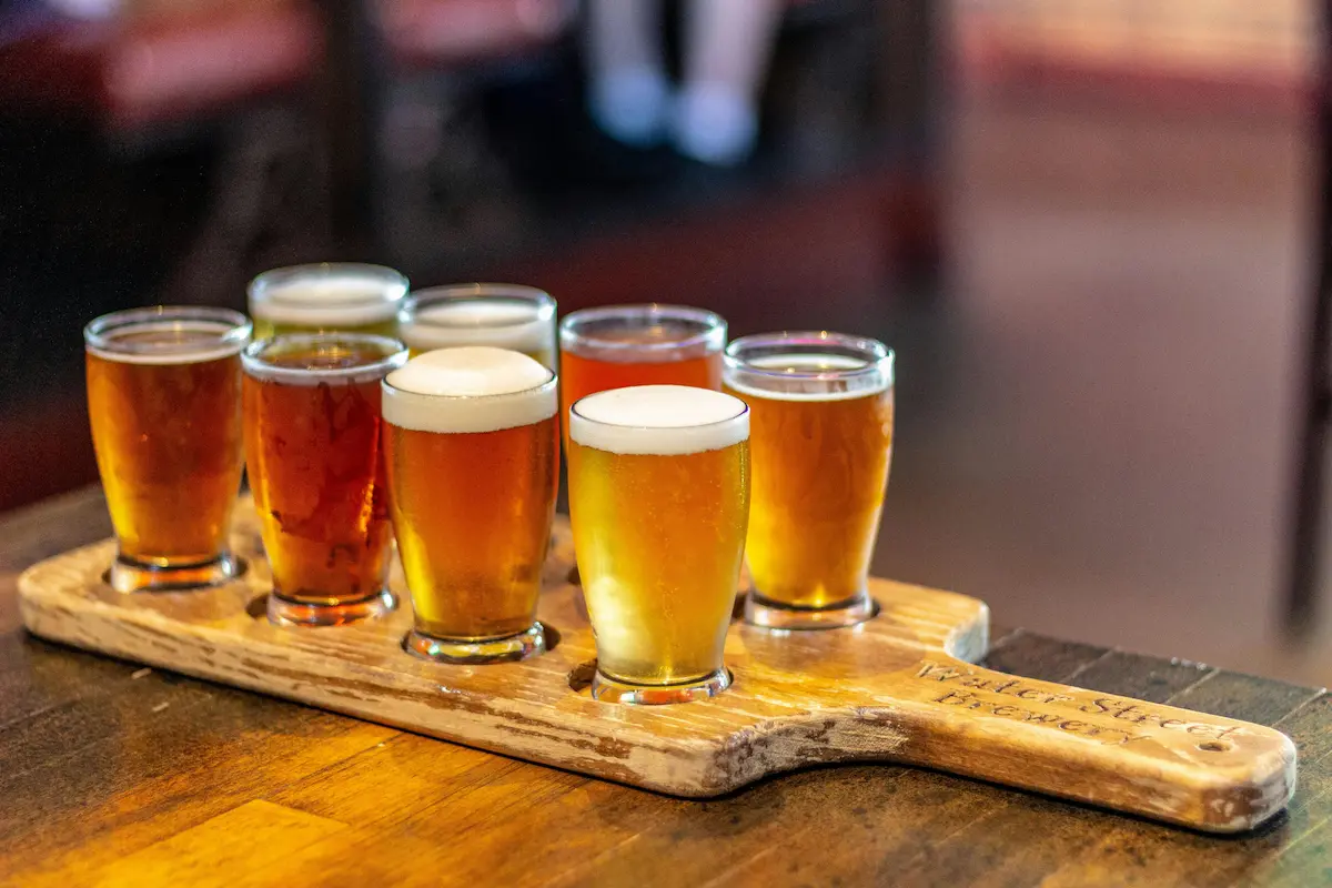 Flight of craft beers on wooden paddle at Wilmington NC brewery