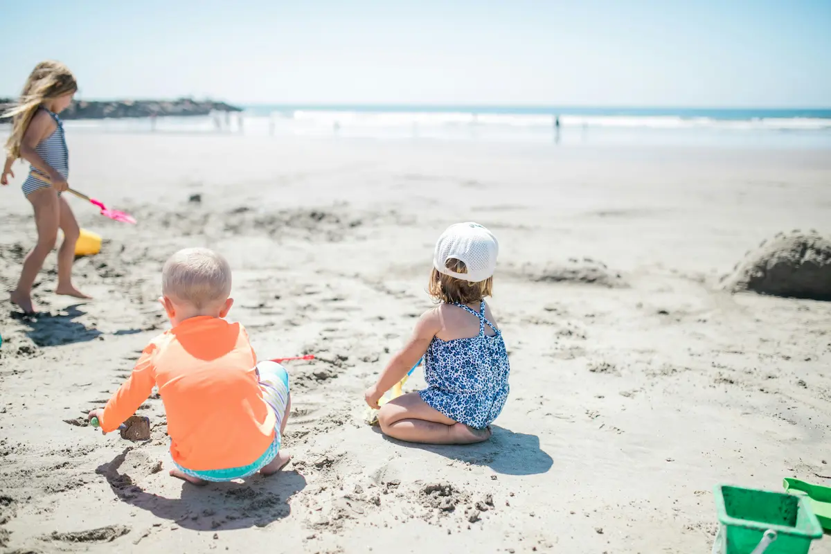 Kids playing in the sand on a Wilmington NC beach